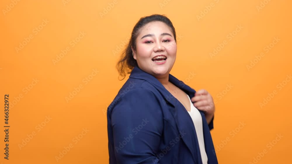 Happy woman plus pose with yellow background. Body positive plus size female lives happily and is proud of herself. Happy woman plus pose with yellow background. Body positive plus size female lives happily and is proud of herself.