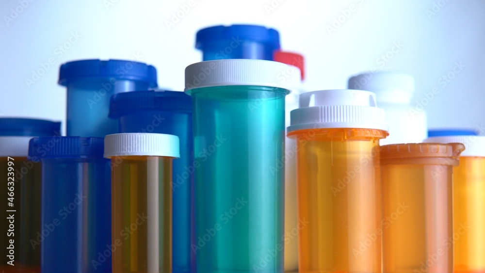 Various pills bottles macro close up shot. Production of medicines bottles. Pharmaceutical concept of healthcare, pharma industry, medication and drugs production. Medical research and trials. Various pills bottles macro close up shot. Production of medicines bottles. Pharmaceutical concept of healthcare, pharma industry, medication and drugs production. Medical research and trials.