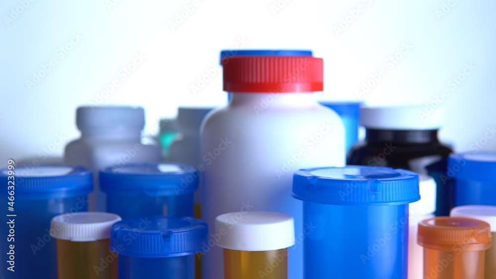 Various pills bottles macro close up shot. Production of medicines bottles. Pharmaceutical concept of healthcare, pharma industry, medication and drugs production. Medical research and trials. Various pills bottles macro close up shot. Production of medicines bottles. Pharmaceutical concept of healthcare, pharma industry, medication and drugs production. Medical research and trials.