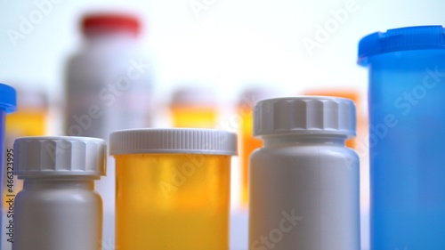 Various pills bottles macro close up shot. Production of medicines bottles. Pharmaceutical concept of healthcare, pharma industry, medication and drugs production. Medical research and trials.