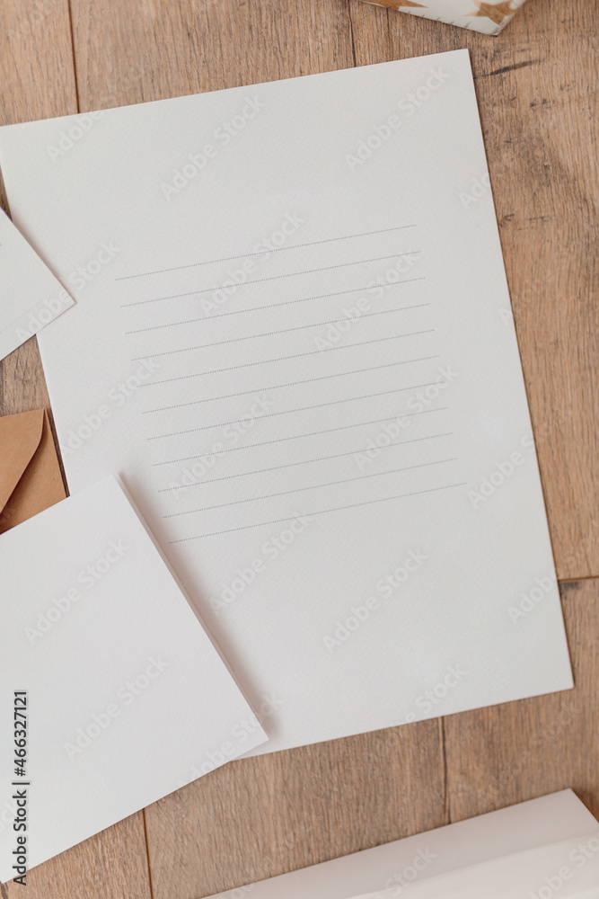 Styled craft envelope, blank card on wooden background. Flat lay. Mockup template. View from above. Top view Styled craft envelope, blank card on wooden background. Flat lay. Mockup template. View from above. Top view