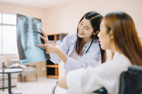 Close up X-ray film with doctor's hand pointing to explain skeleton to patient in hospital