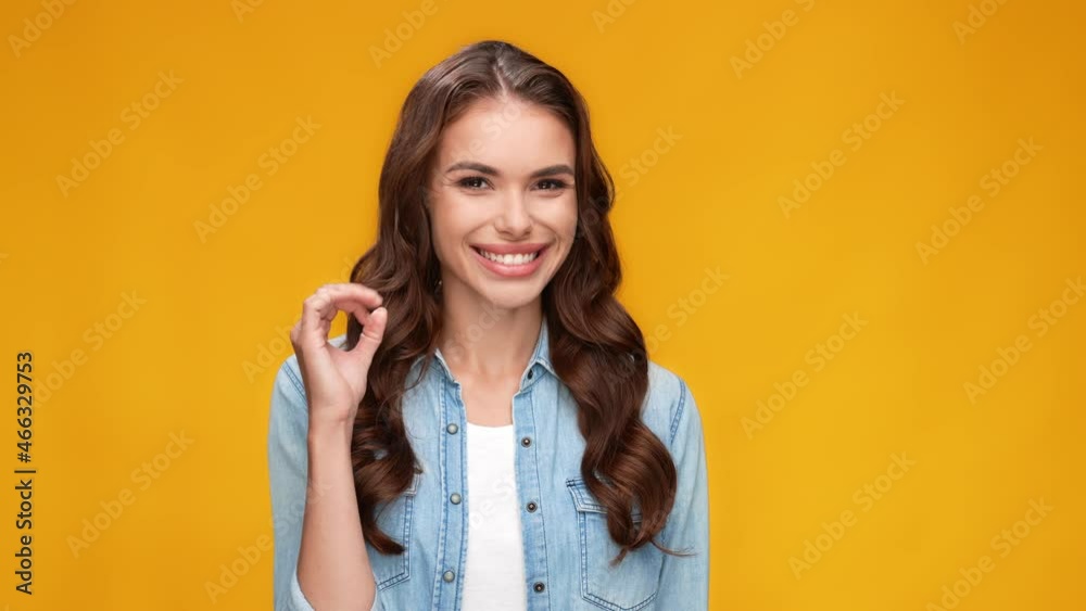 Cheerful nice charming lady show okey sign flirty tricky blink eye