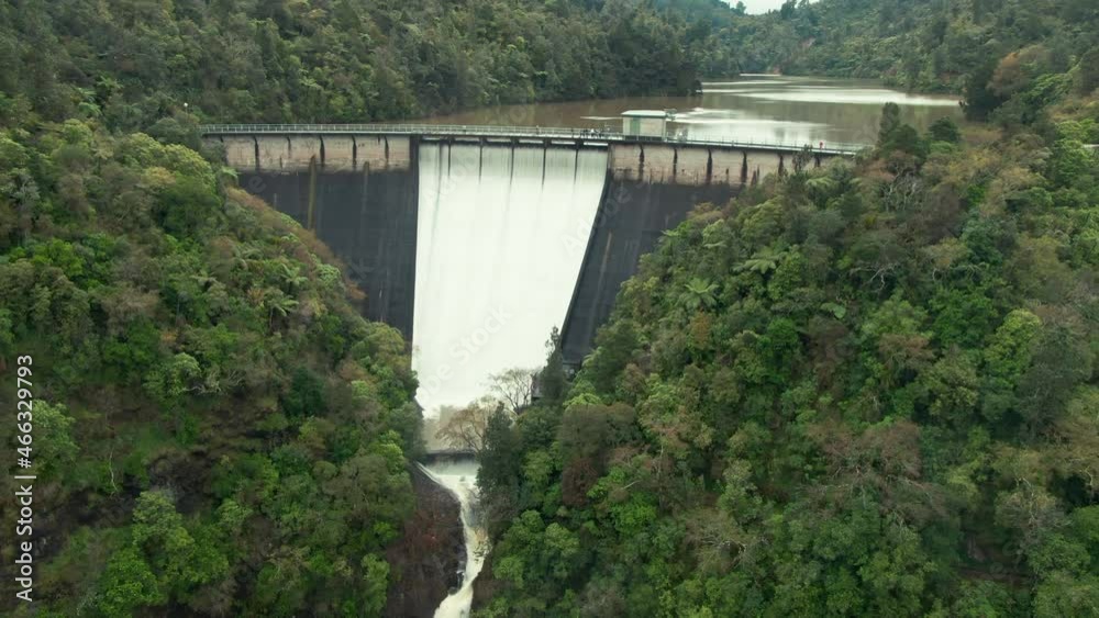 Aerial: Water Reservoir spillway of the Nihotupu Reservoir, overflowing from heavy rain. Auckland, New Zealand Aerial: Water Reservoir spillway of the Nihotupu Reservoir, overflowing from heavy rain. Auckland, New Zealand