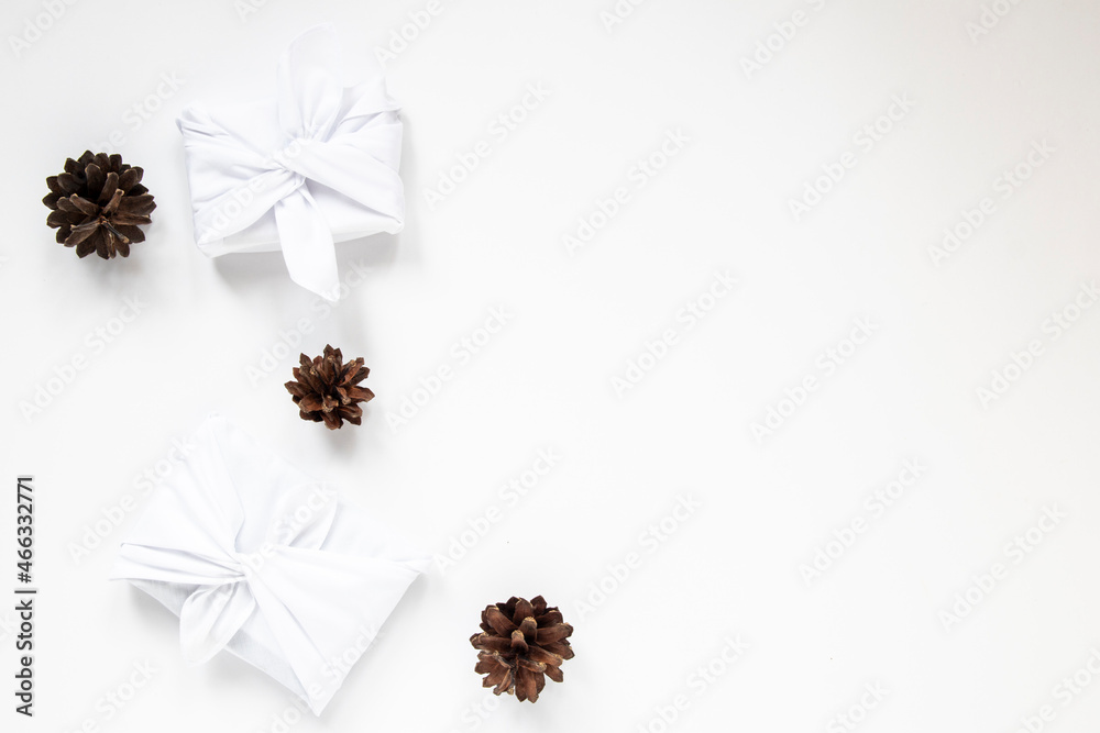 Furoshiki is a traditional Japanese tying technique. Flatlay White gifts with cones. Ecological gift wrapping. the concept of waste-free use of gift wrapping. Furoshiki is a traditional Japanese tying technique. Flatlay White gifts with cones. Ecological gift wrapping. the concept of waste-free use of gift wrapping.