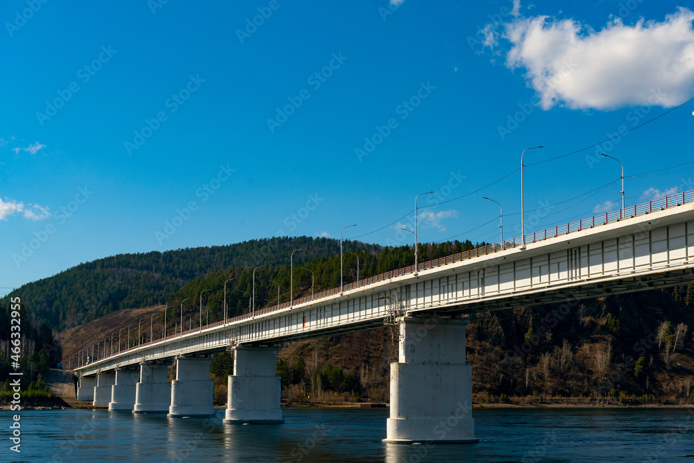 Long concrete bridge over the river on massive pillars.
