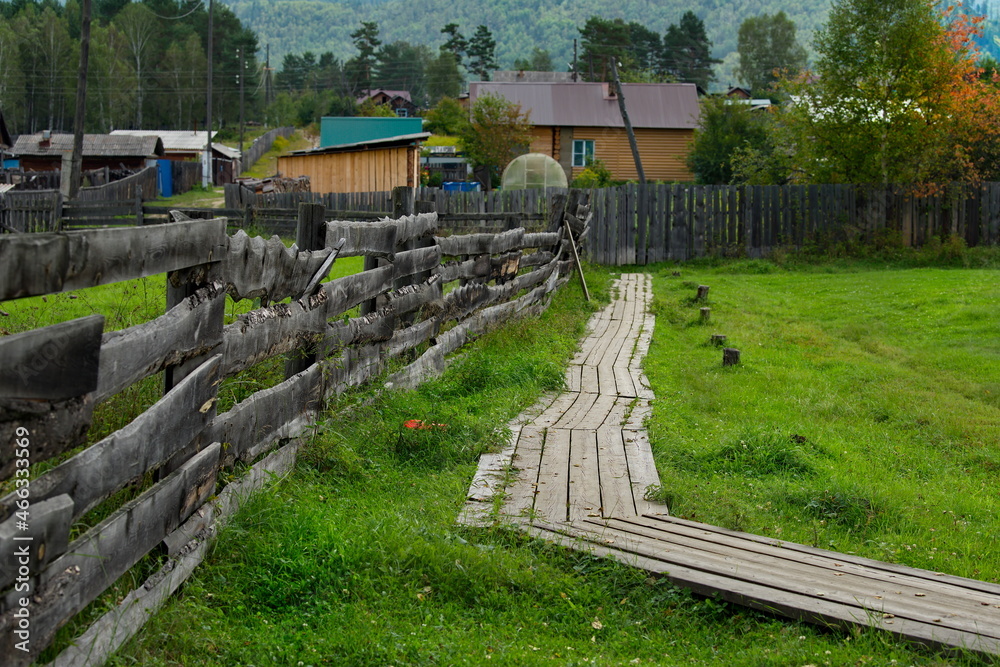 Russia. Transbaikalia, Chita region. A wooden fence made of boards and ...