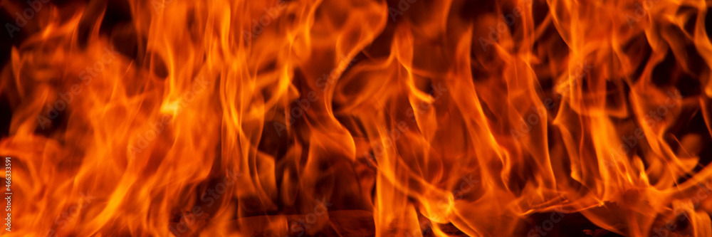 Abstract flame, banner, fire flame texture, background. Blurred moving tongues of fire on a dark background. Abstract flame, banner, fire flame texture, background. Blurred moving tongues of fire on a dark background.