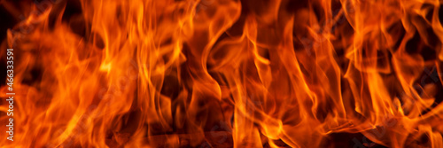 Abstract flame, banner, fire flame texture, background. Blurred moving tongues of fire on a dark background.