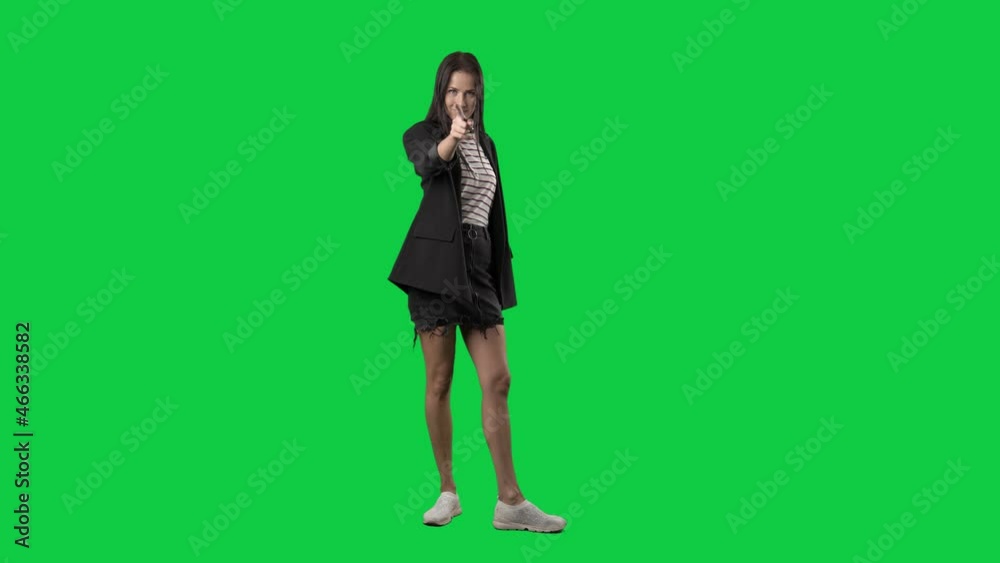 Back view of woman in suit jacket turning at camera picking you. Slow motion. Full body isolated on green screen background Back view of woman in suit jacket turning at camera picking you. Slow motion. Full body isolated on green screen background