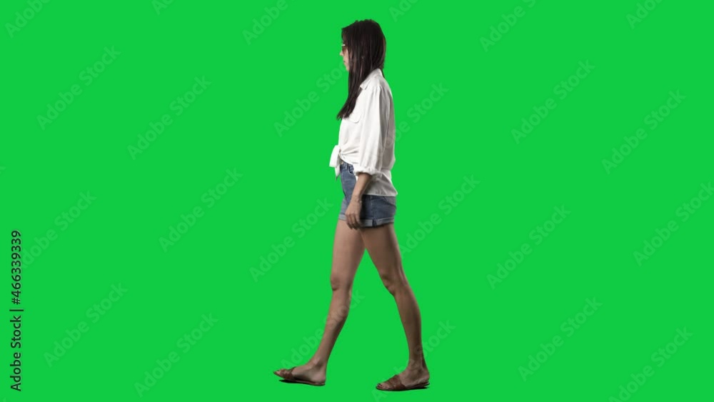 Side view of walking stylish summer girl with sunglasses in sandals. Full body isolated on green screen background Side view of walking stylish summer girl with sunglasses in sandals. Full body isolated on green screen background