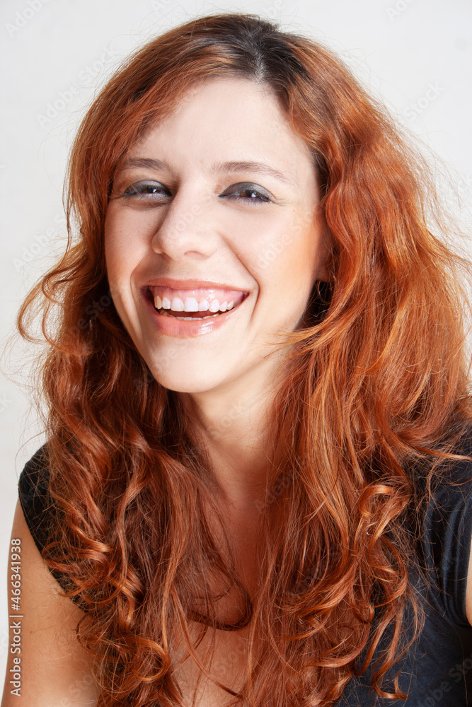 rad hair woman smiling an look at camera
