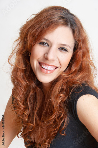 portrait of red-haired woman with big smile