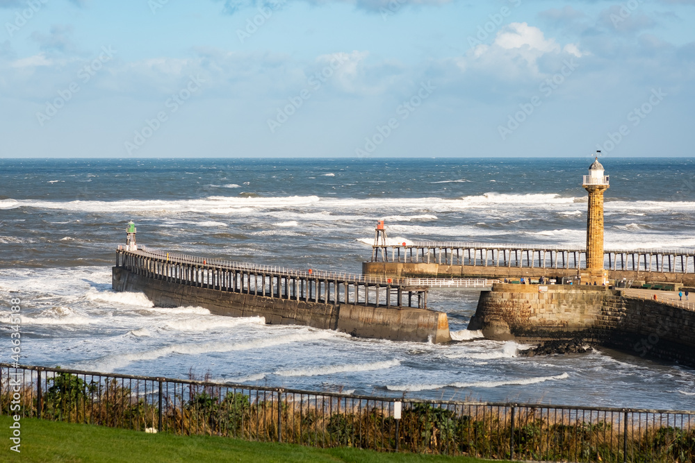 Rough seas and Whitby harbour captured from the cliff tops above in North Yorkshire, October 2021