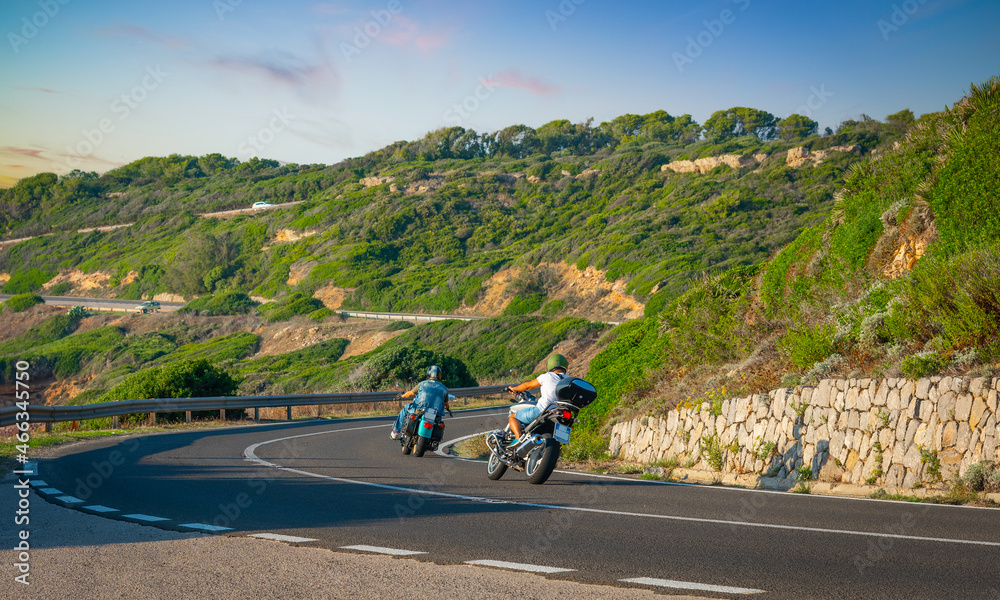Bikers on winding coastal road in Sardinia