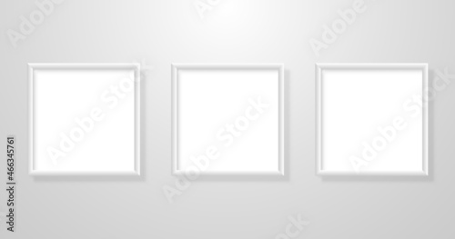 Painting mockup three. Realistic photo frames with shadow. Pictures blank set hanging on white wall. Square light frames collection. Vector illustration