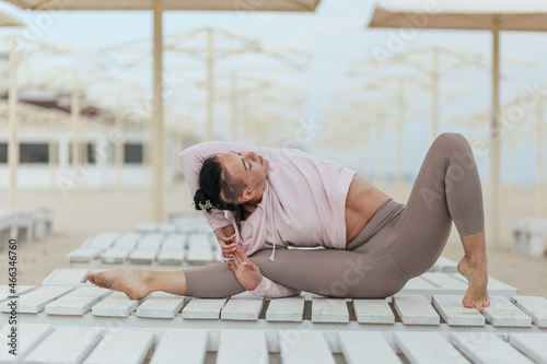 yoga postures, girl in pink hoodie practice yoga
