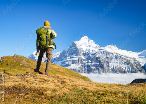 Tourist with a backpack in the mountains. Mountain hiking in the high mountains. Travel and adventure. Active life. Landscape in the summertime. Photo with high resolution.