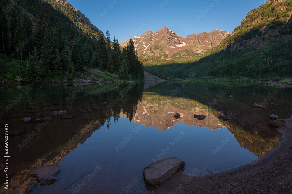 Maroon Bells, crystal clear Maroon Lake and beautiful summer reflections in early morning near Aspen, Colorado
