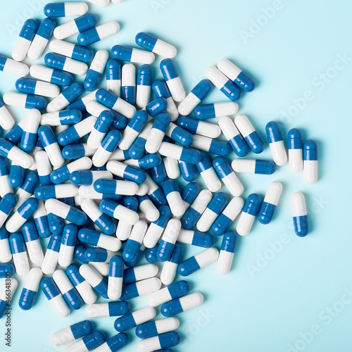 White and blue capsules on a light background