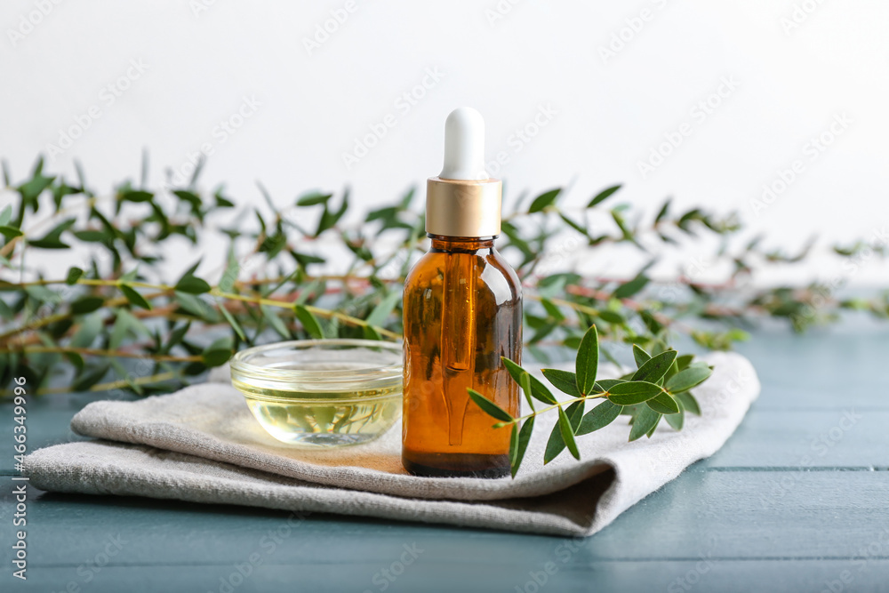 Bowl with eucalyptus oil and dropper bottle on table