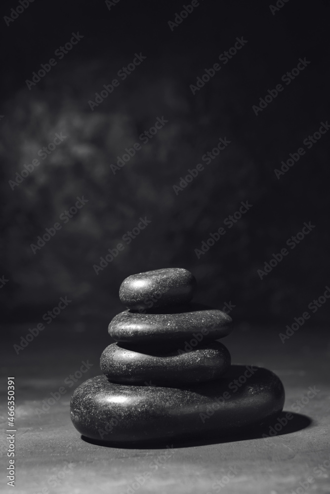 Stack of black zen stones on dark background Stock Photo | Adobe Stock