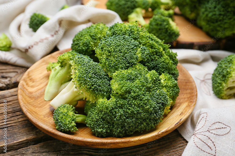 Plate with healthy broccoli cabbage on wooden background
