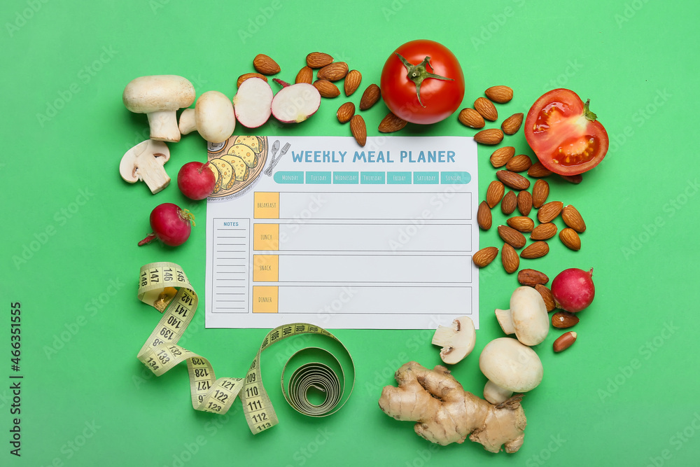 Meal plan, healthy products and measuring tape on green background Meal plan, healthy products and measuring tape on green background