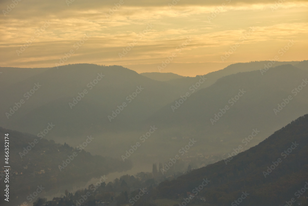 sunrise over mountains rolling landscape with autumn fog over the river