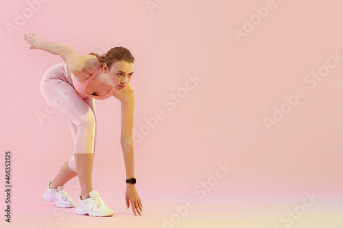 Sporty female runner on col...
