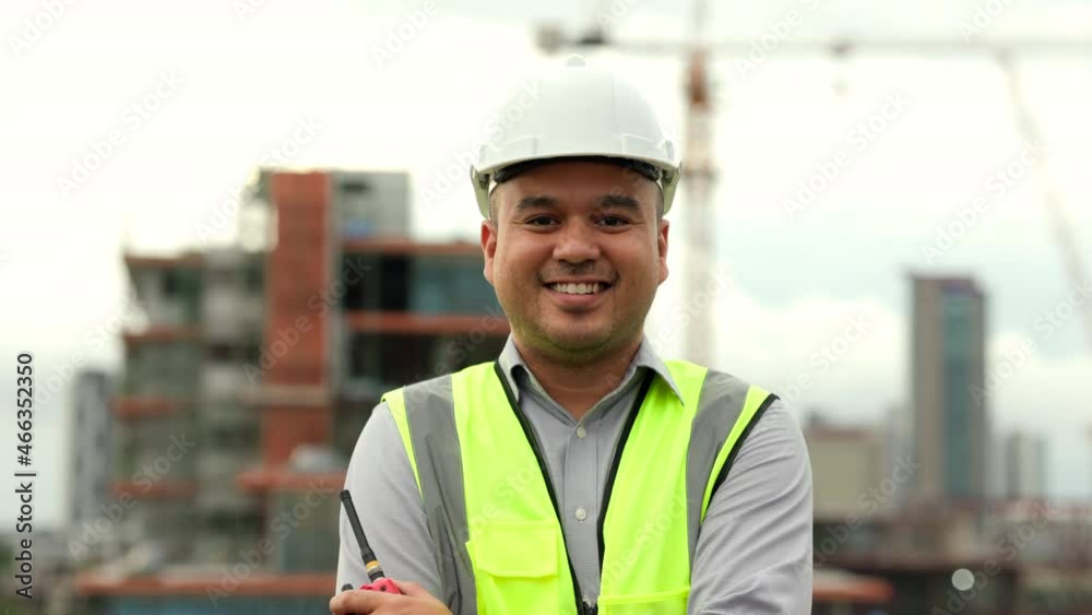 Engineer handsome man walking smile and proud of the work with white safety helmet in city construction site . Standing on rooftop building construction at capital. Architect asian man succeed working Engineer handsome man walking smile and proud of the work with white safety helmet in city construction site . Standing on rooftop building construction at capital. Architect asian man succeed working