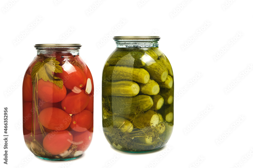 Jars of pickled cucumbers and tomatoes on white background, isolate. Preparations for winter. Jars of pickled cucumbers and tomatoes on white background, isolate. Preparations for winter.