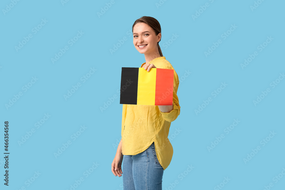 Young woman with flag of Belgium on color background Young woman with flag of Belgium on color background