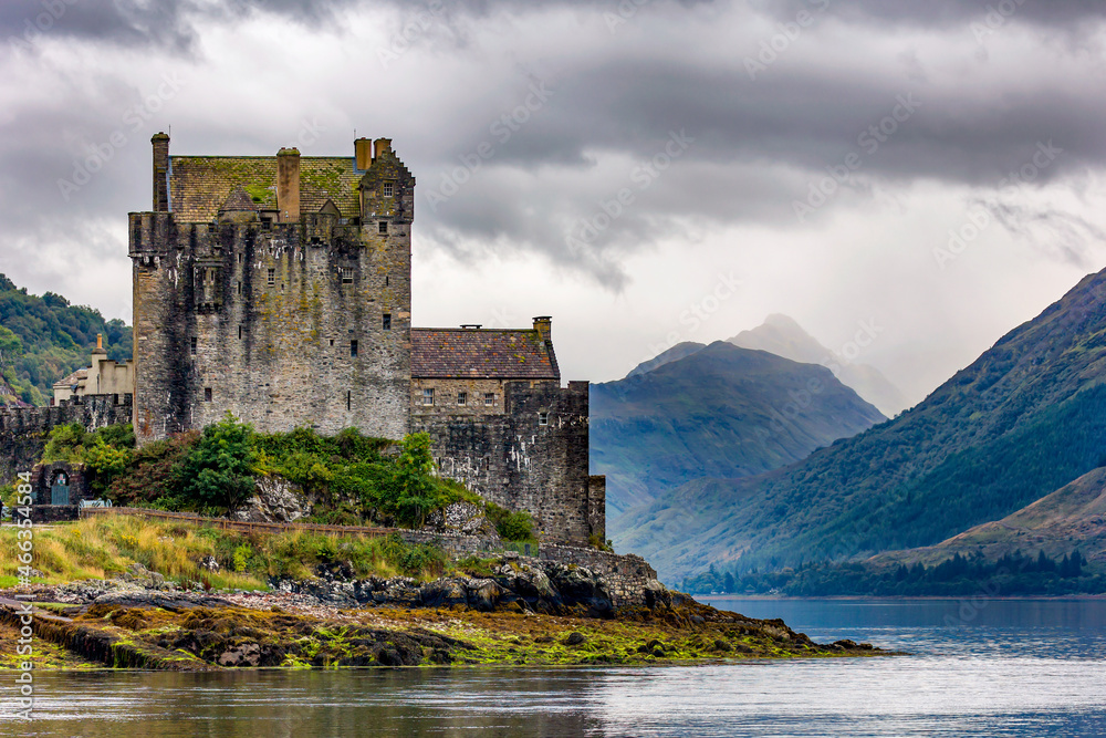 Dramatic Scottish castle with a moody sky on the shore of a sea loch (Eilean Donan, Highlands)