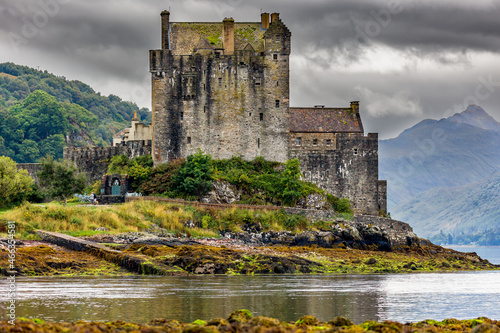 Dramatic Scottish castle with a moody sky on the shore of a sea loch (Eilean Donan, Highlands) photo