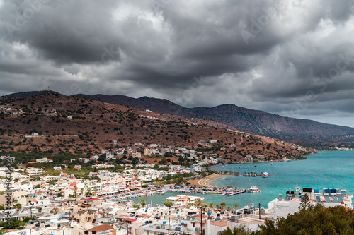 Stormy clouds and bands of rain over the Greek tourist resort town of Elounda on the island of Crete © whitcomberd