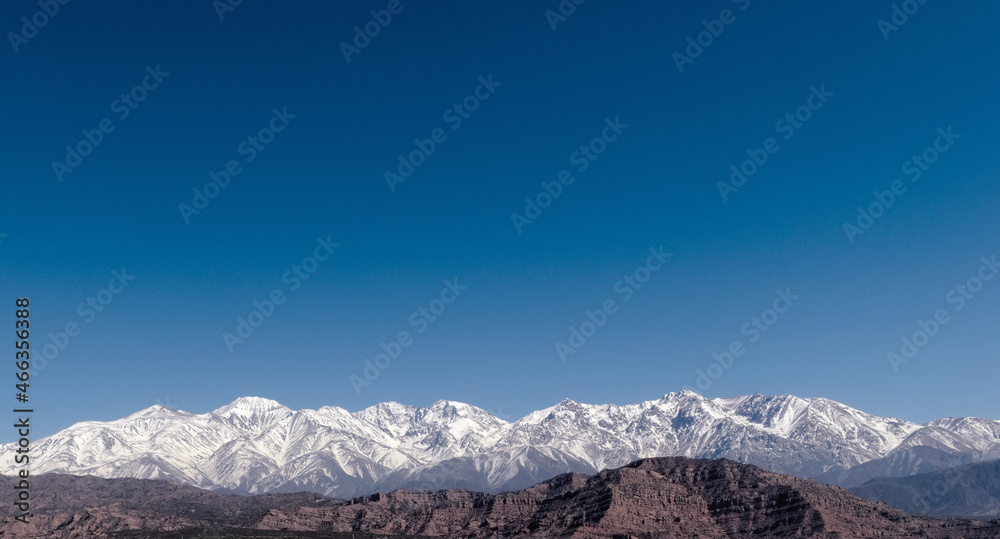 Snowy Andes mountains, as seen from Potrerillos, Mendoza, Argentina, in a sunny, bright winter day. Snowy Andes mountains, as seen from Potrerillos, Mendoza, Argentina, in a sunny, bright winter day.