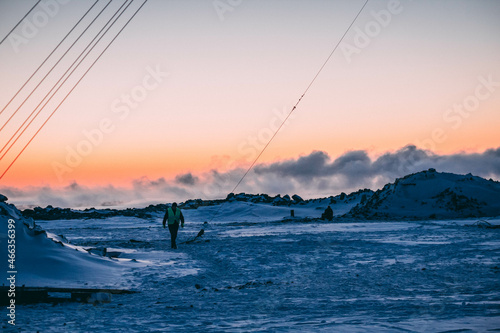 People work in cold difficult conditions in winter in the mountains, at dawn 