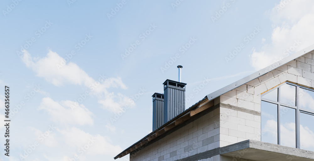 A new house under construction with large windows