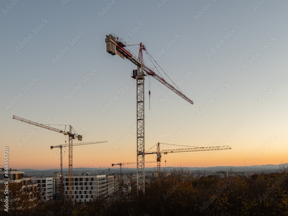 Construction crane on a construction site used for the construction of residential houses Construction crane on a construction site used for the construction of residential houses