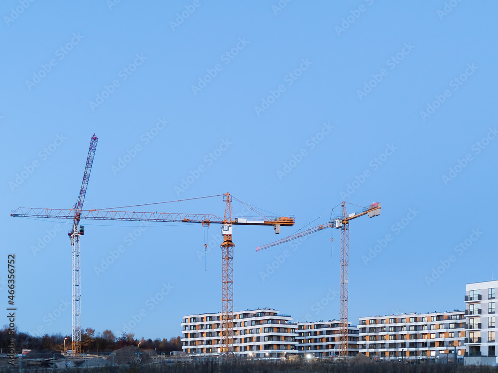Construction crane on a construction site used for the construction of residential houses Construction crane on a construction site used for the construction of residential houses