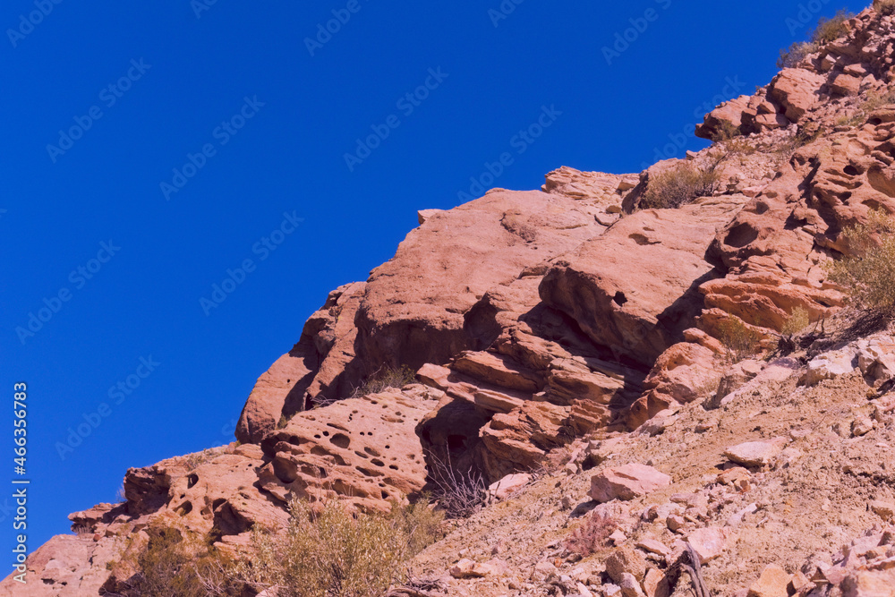 Rocky outcrop in a reddish arid landscape in Mendoza, Argentina.