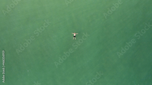 Aerial photo of man relaxing on green sea at Brighton during summer in Sussex England
