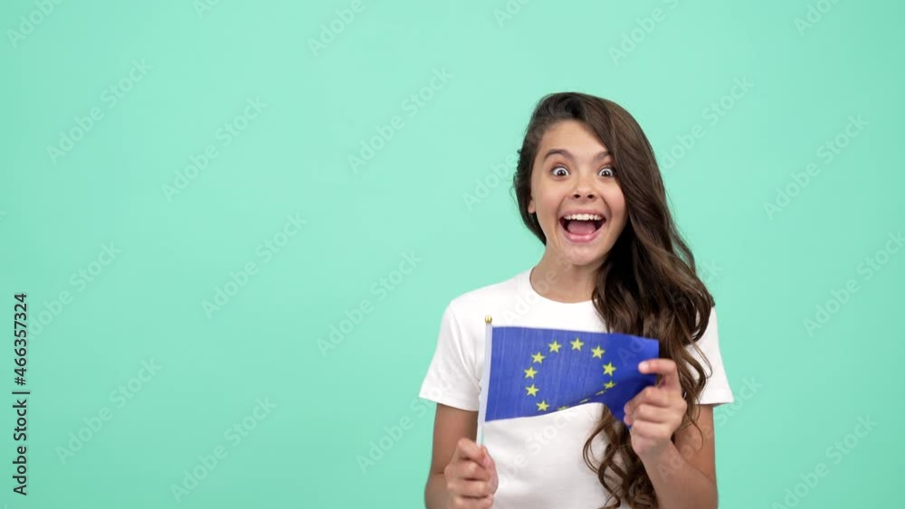 surprised child waving european union flag on blue background showing thumb up, schengen visa surprised child waving european union flag on blue background showing thumb up, schengen visa