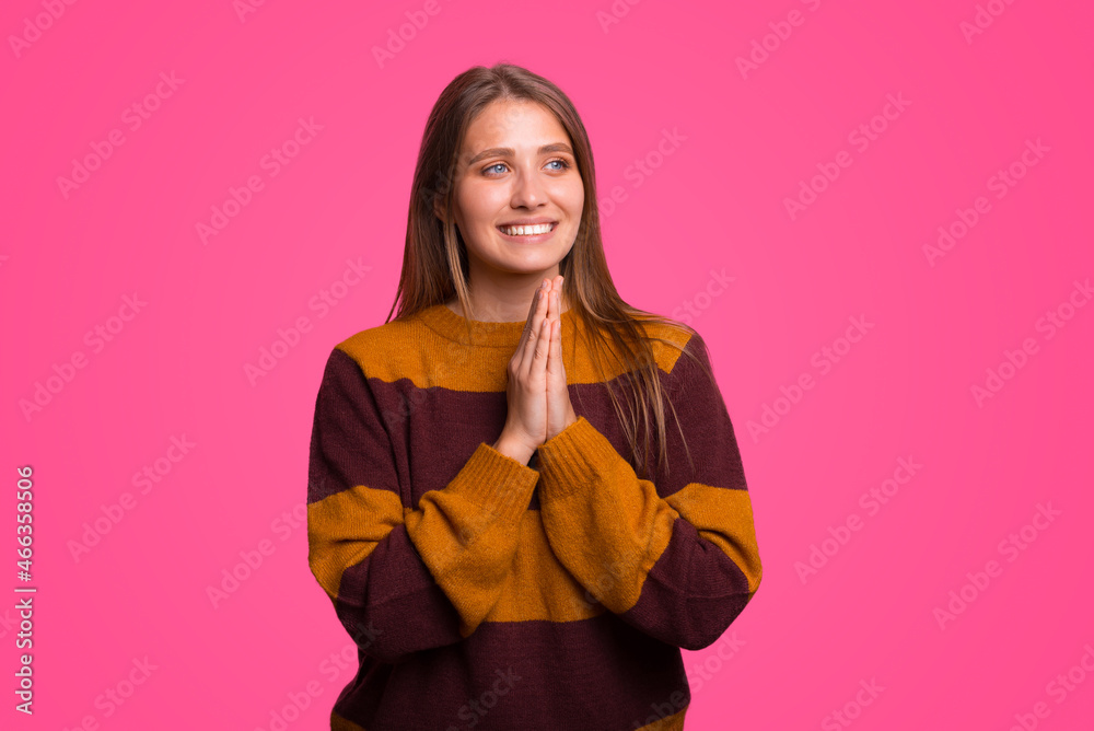 Smiling young woman is holding hands together for prayer. Smiling young woman is holding hands together for prayer.