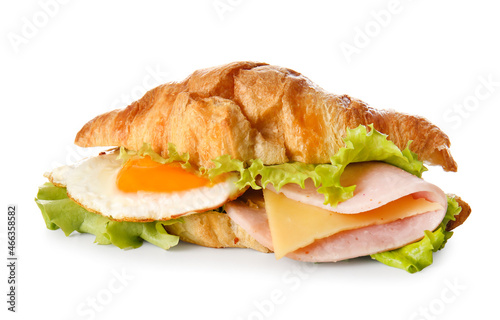 Delicious croissant sandwich with egg and meat on white background