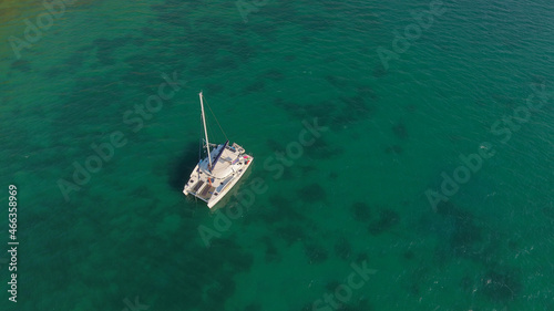 Aerial photo of moored sailing boat at Vathiavali port town in West Greece © Haris Photography