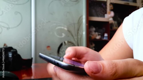 Girl using smartphone close up sliding screen, pressing with finger, surfing internet, social media, shopping online, typing text. Chatting, communicating and play via mobile phone in two hands