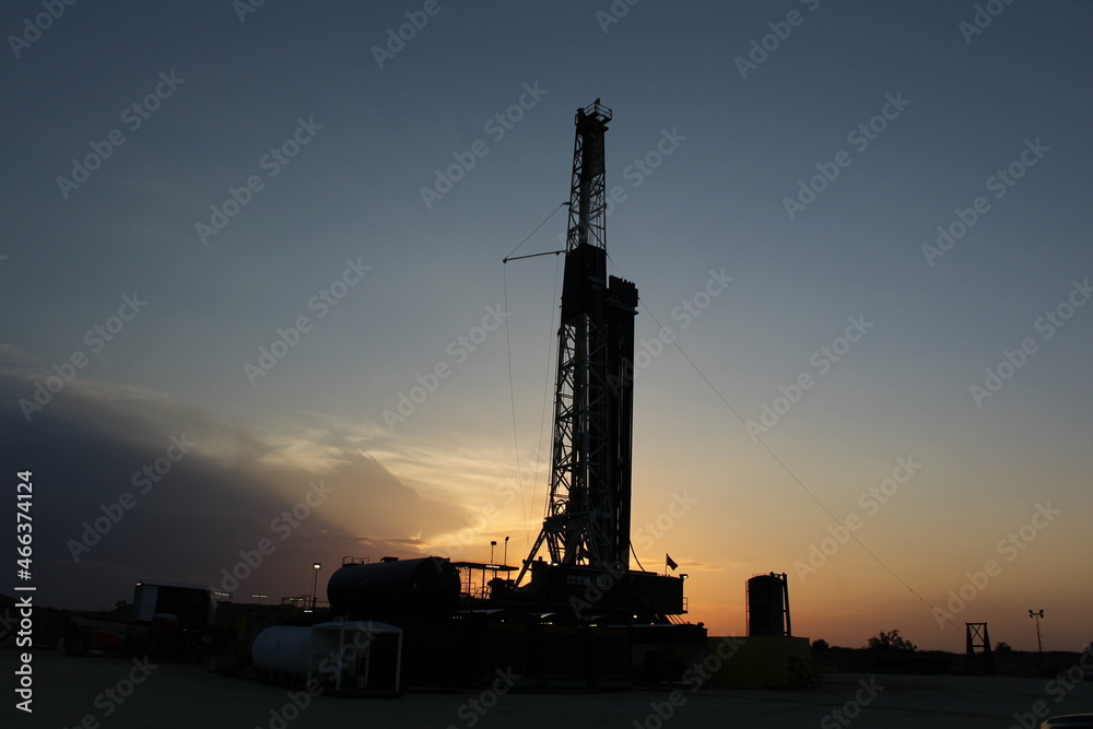 Beautiful sunset going over an oil and gas drilling rig in West Texas Permain Basin Beautiful sunset going over an oil and gas drilling rig in West Texas Permain Basin
