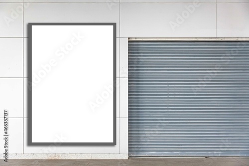 A large blank billboard at the entrance to the building